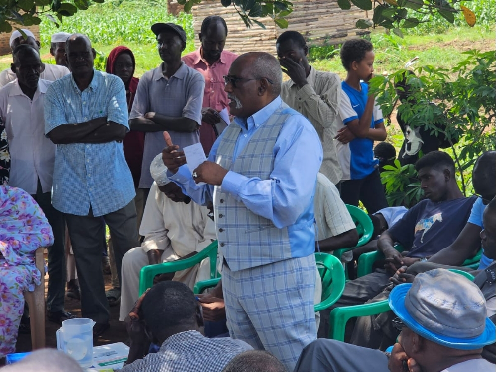 Sudanese refugees in Kiryandongo Refugee Camp attending a community meeting to address ongoing security concerns and advocate for protection.
