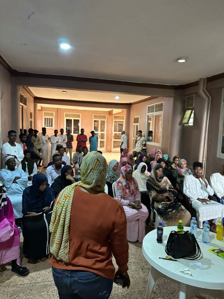 SHRA staff member explaining refugee support programs